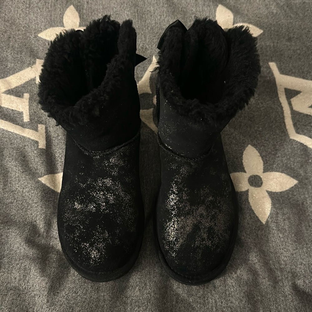 UGGs for sale. Women’s size 7. They are black with gold and a bow on the back.
